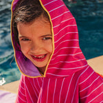 Child wearing burgundy hooded beach poncho after swimming lightweight quick-dry towel